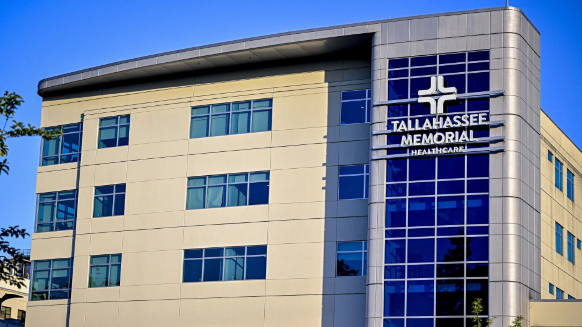 An exterior view of the modern, tan-colored multi-story medical building of Tallahassee Memorial HealthCare.