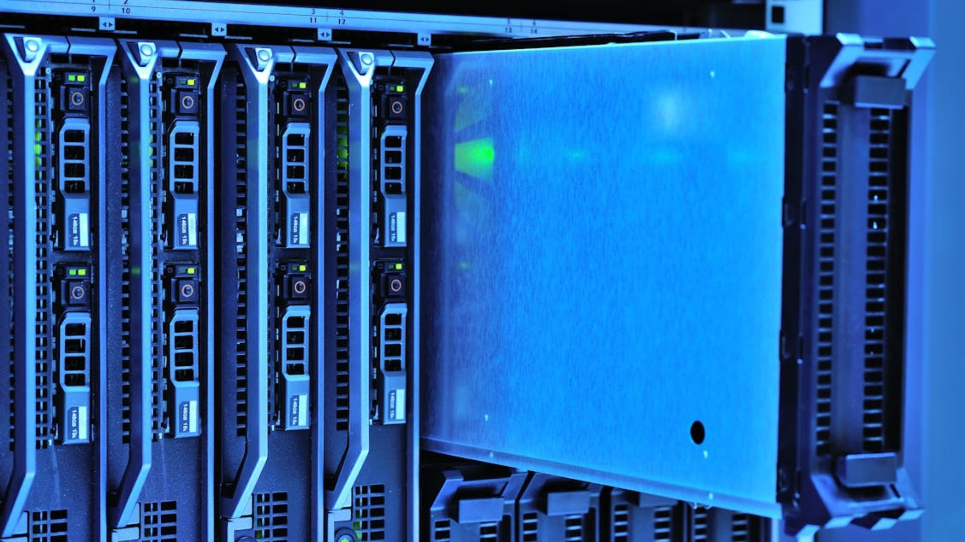 Server rack hardware with blue ambient lighting and green indicator lights.