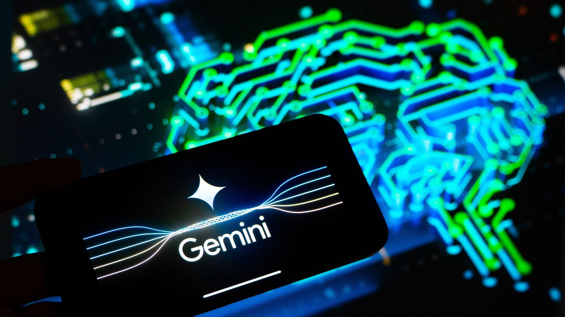 A smartphone displaying "Gemini" with a star logo is held against a digital neon-blue circuit pattern resembling a brain.
