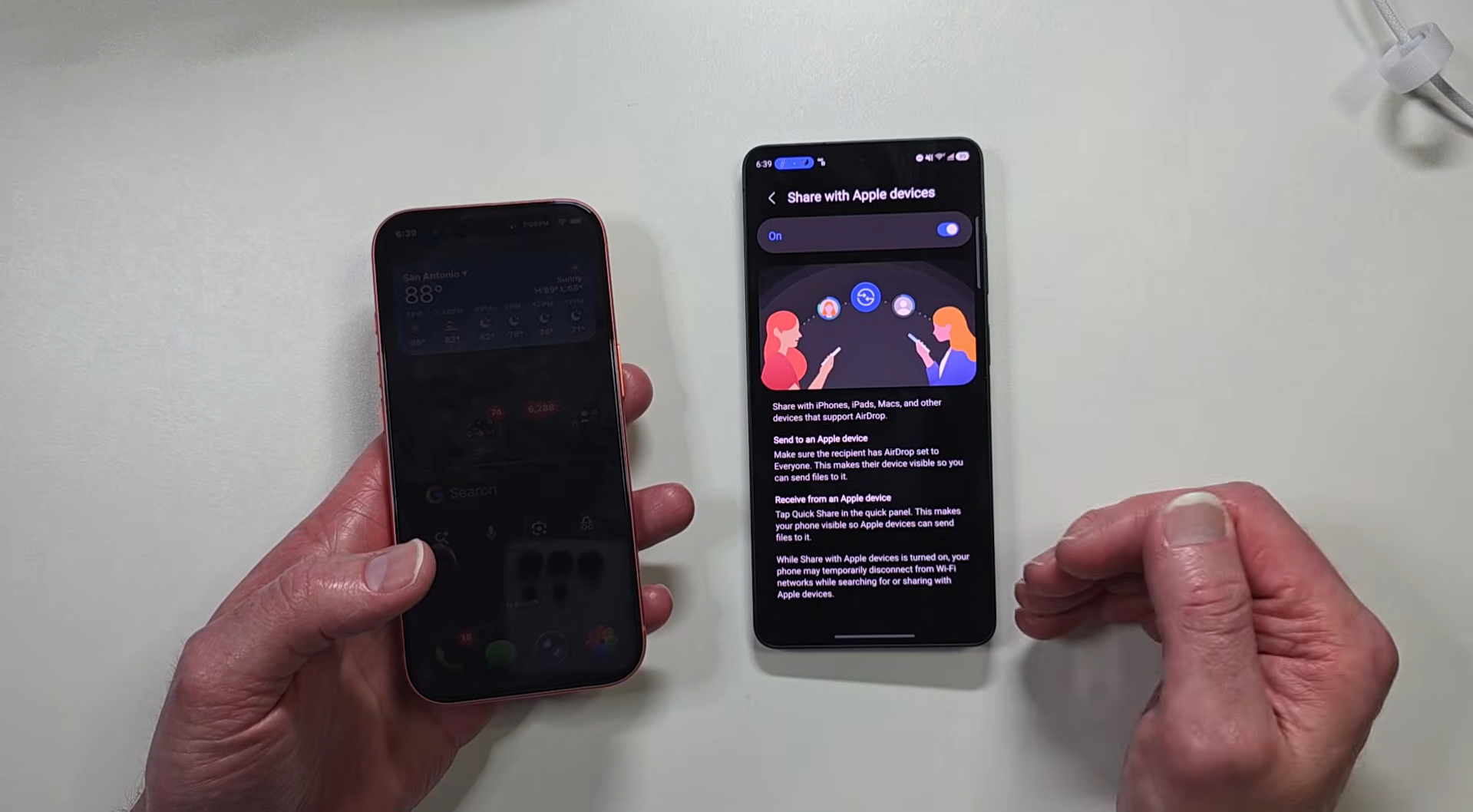 Person holding iPhone next to Samsung Phone displaying file sharing settings screen.