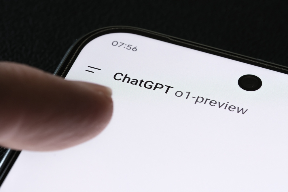 Smartphone screen displaying ChatGPT “o1-preview” interface with a finger tapping the screen.