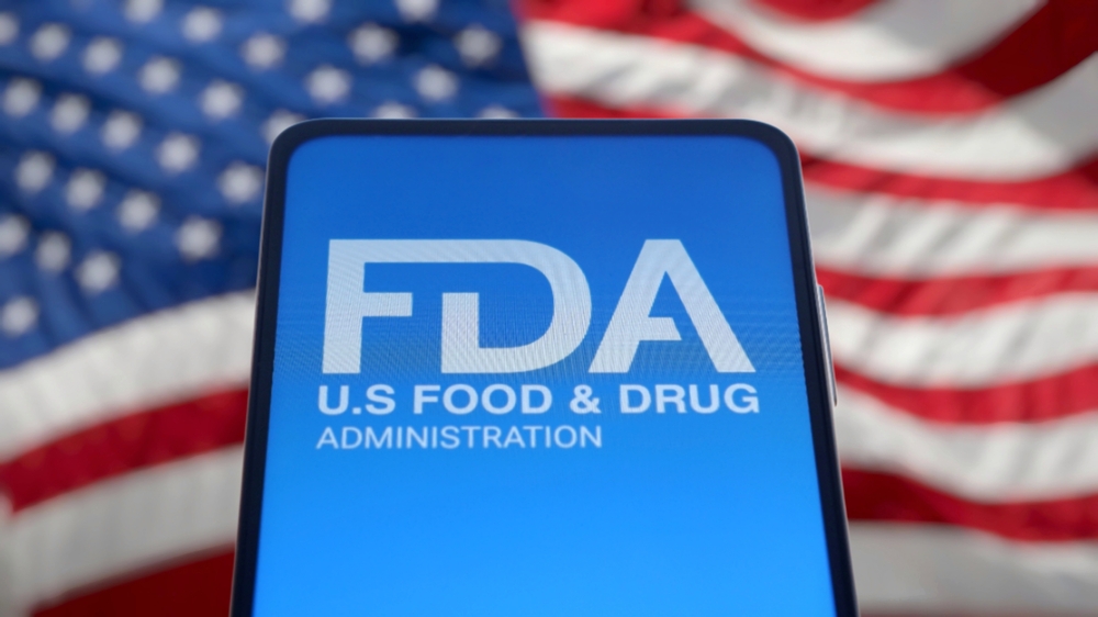 FDA logo displayed on smartphone screen with American flag in background.
