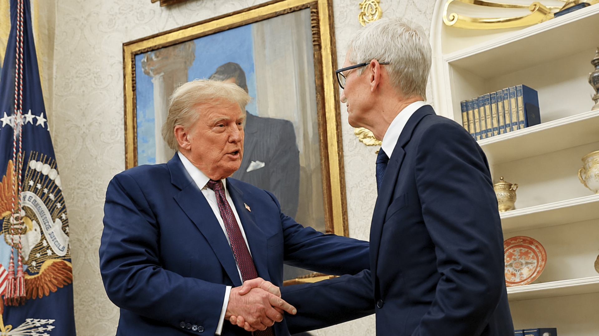 Donald Trump shaking hands with Apple CEO Tim Cook inside the Oval Office, with the Presidential seal flag visible on the left and a framed portrait behind them.