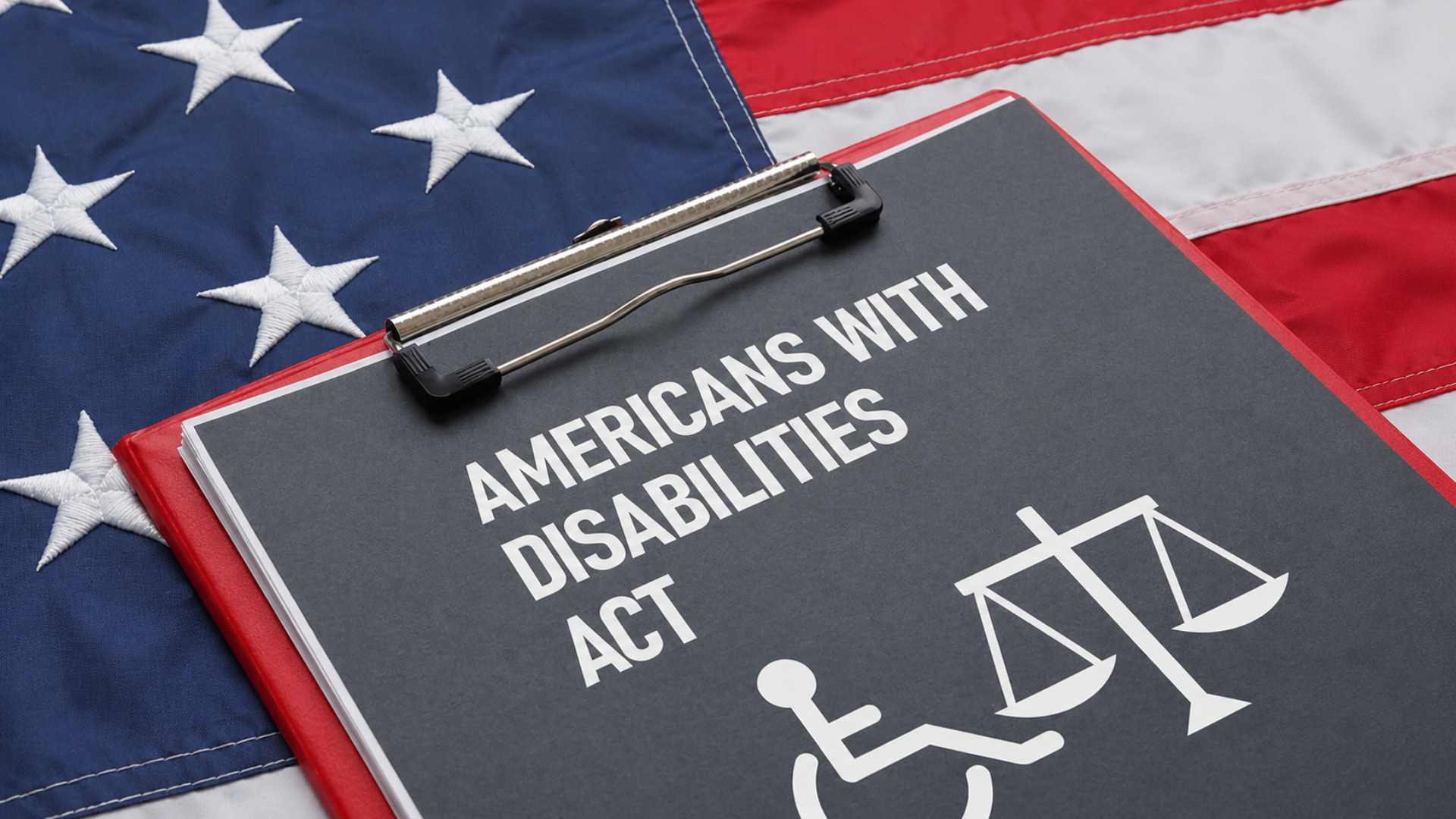 Americans with Disabilities Act document on a clipboard placed over a U.S. flag.