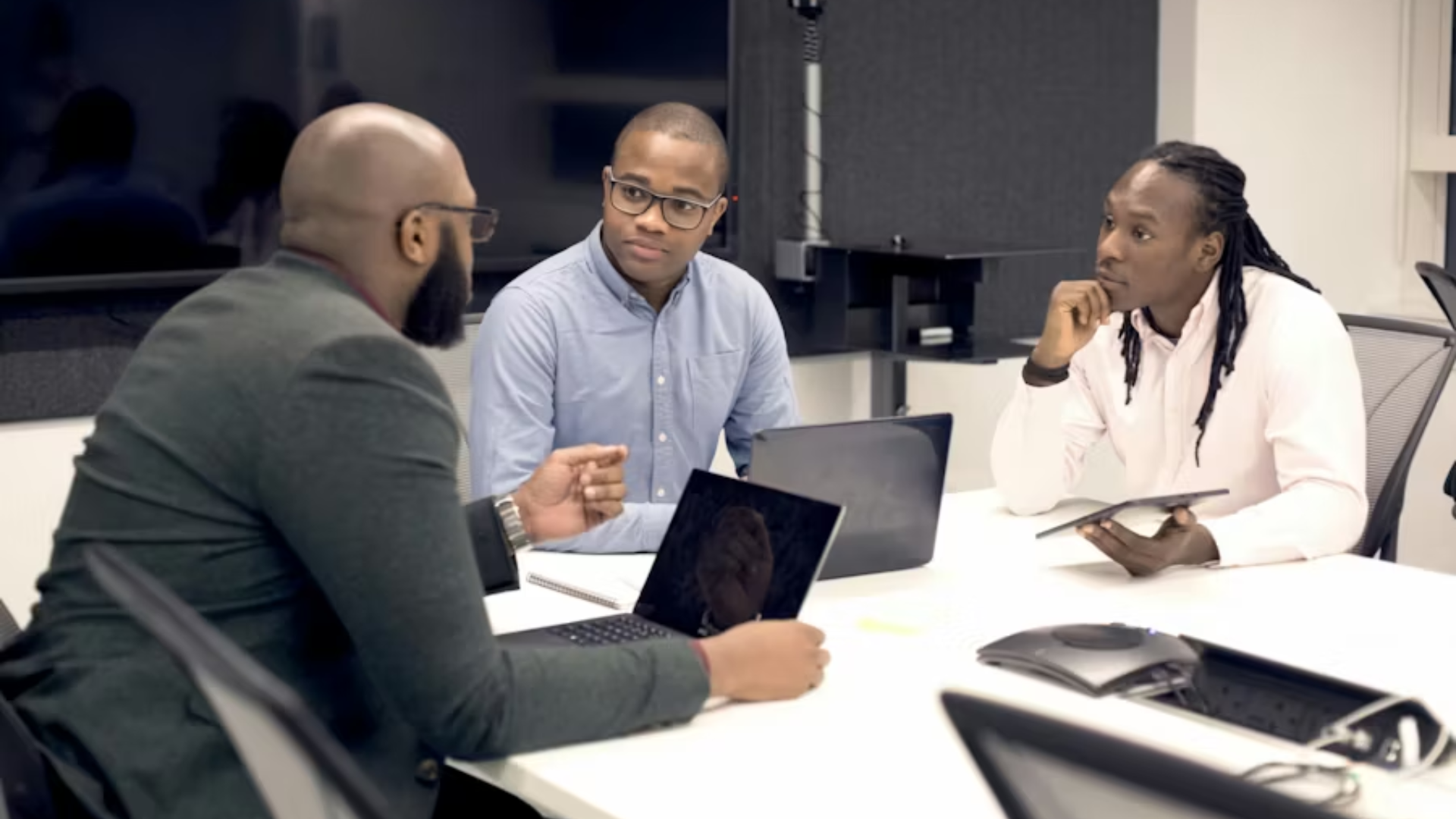 Business professionals discussing work around a conference table.