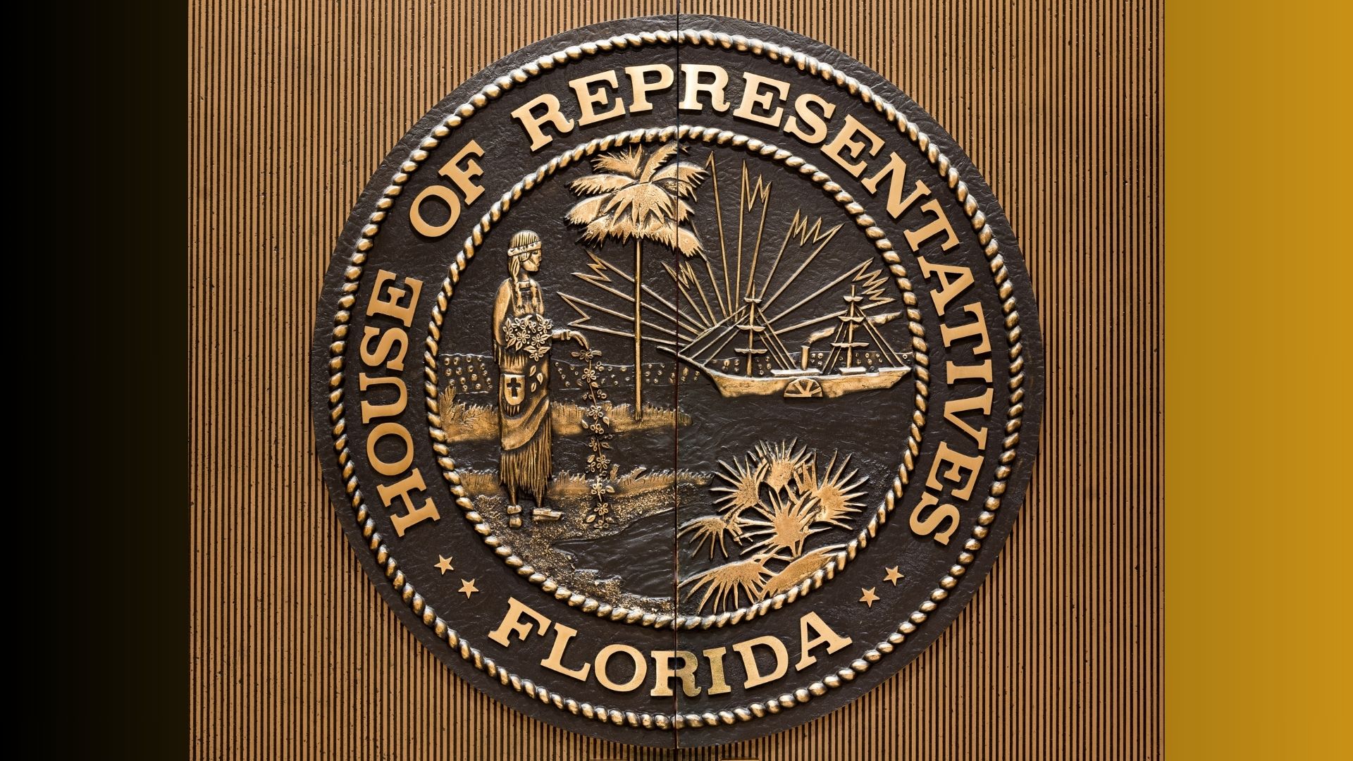 Seal of the Florida House of Representatives displayed inside a government chamber.