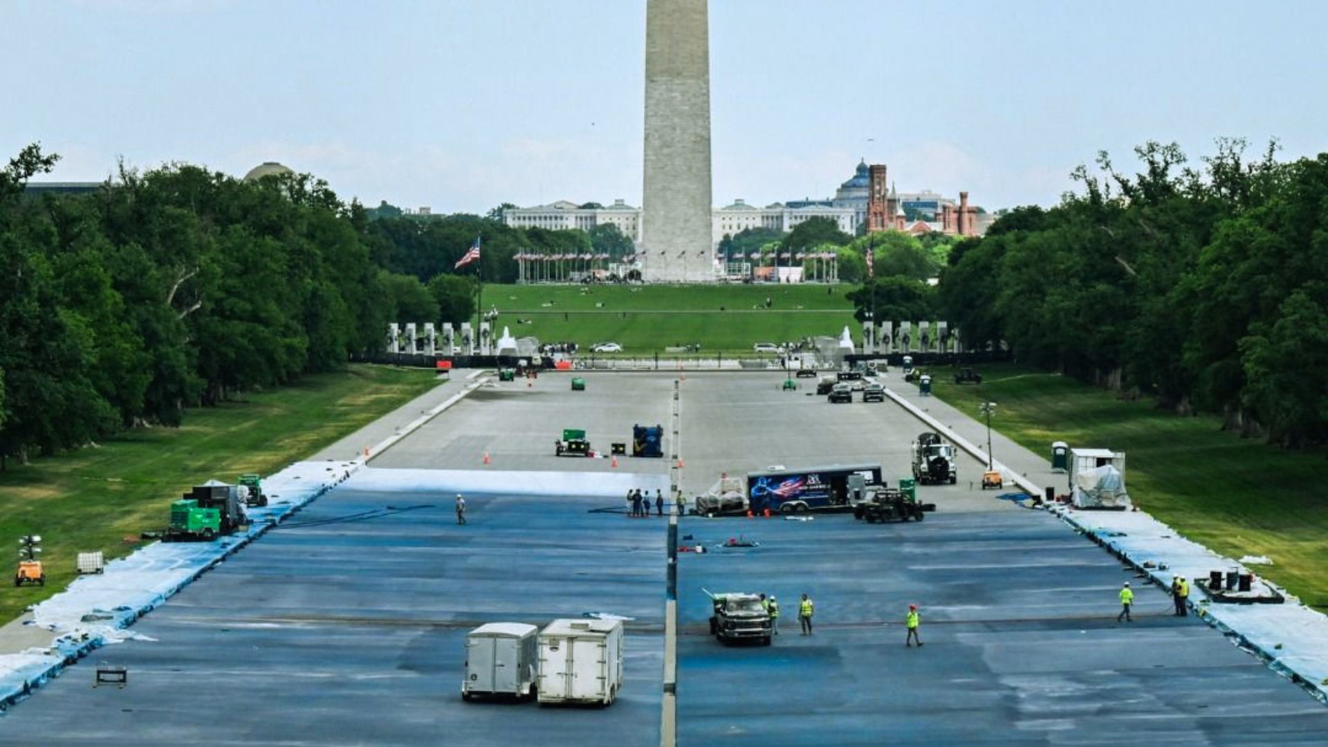 Wide view of the Reflecting Pool renovation showing large-scale repainting work near the National Mall.