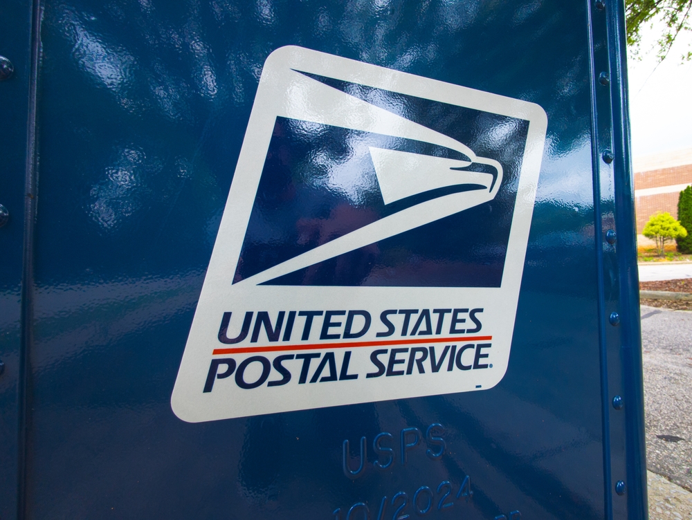 United States Postal Service logo displayed on the side of a USPS mailbox.