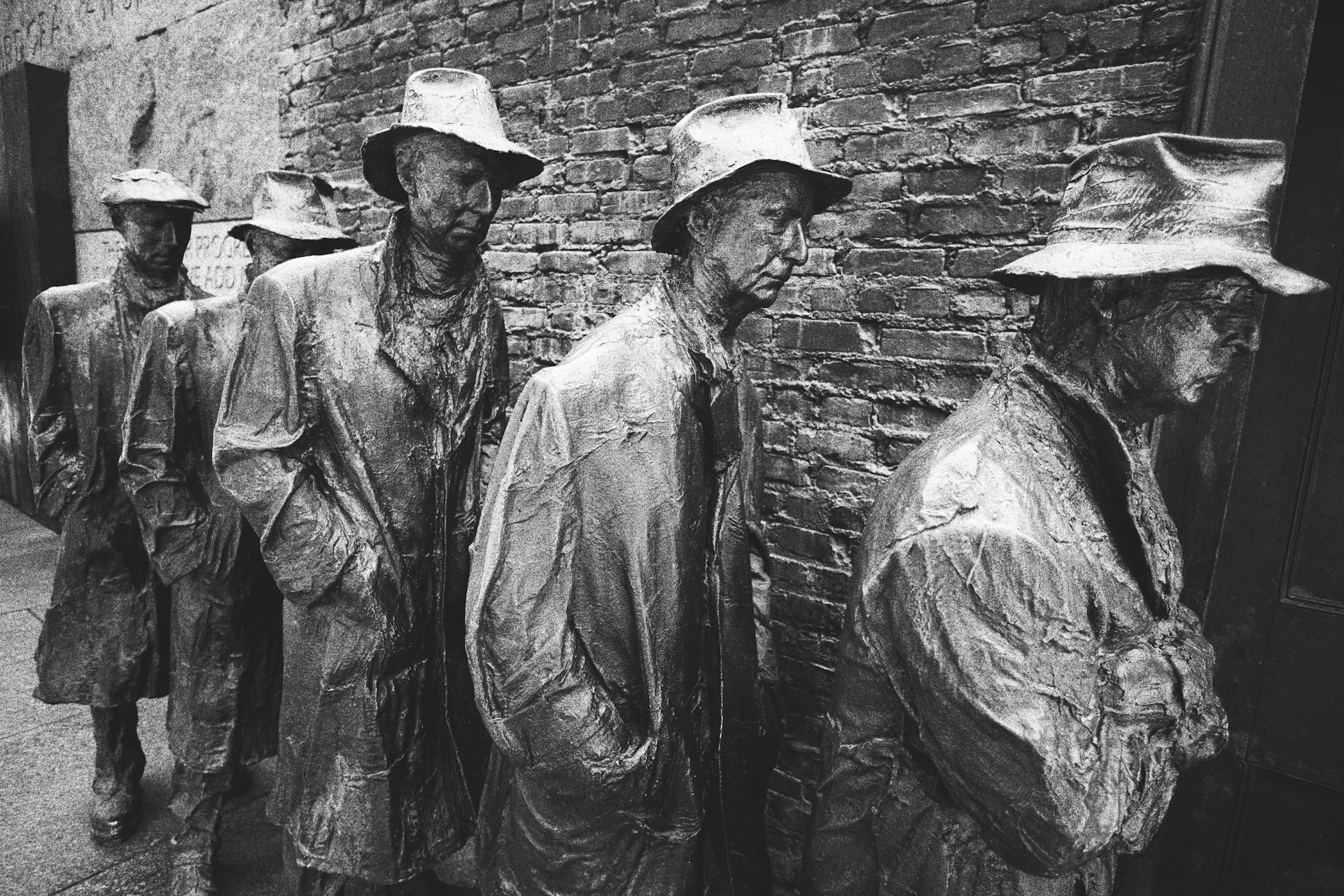Statues of breadline men at the Franklin Delano Roosevelt Memorial depicting the Great Depression.