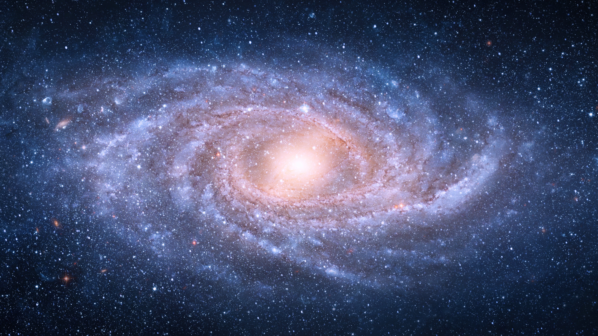 A bright spiral galaxy with a glowing center surrounded by stars in deep space.