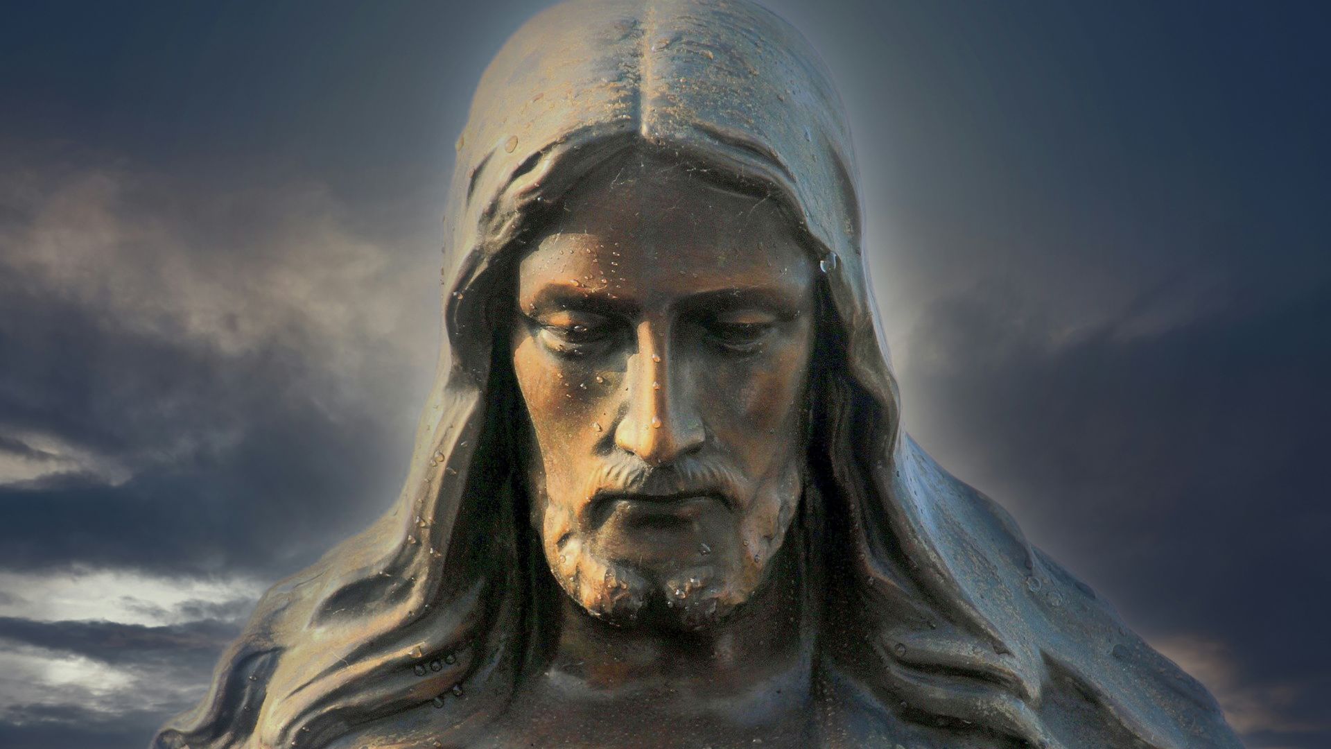 Close-up of a statue of Jesus Christ with an emotional and contemplative expression on His face.