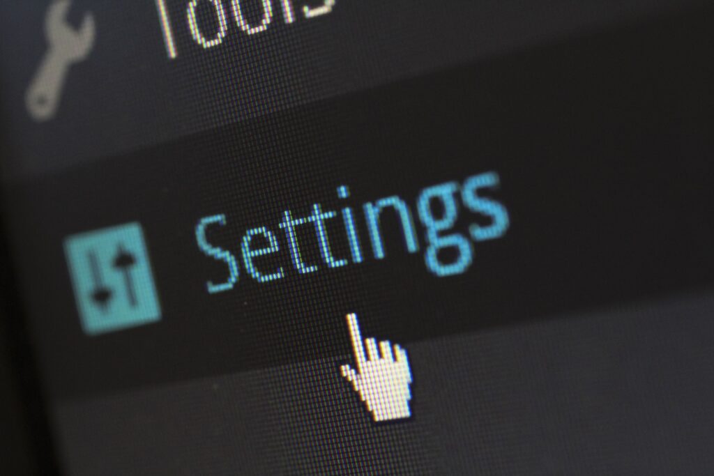 Computer screen displaying a settings menu with a cursor hovering over the Settings option.