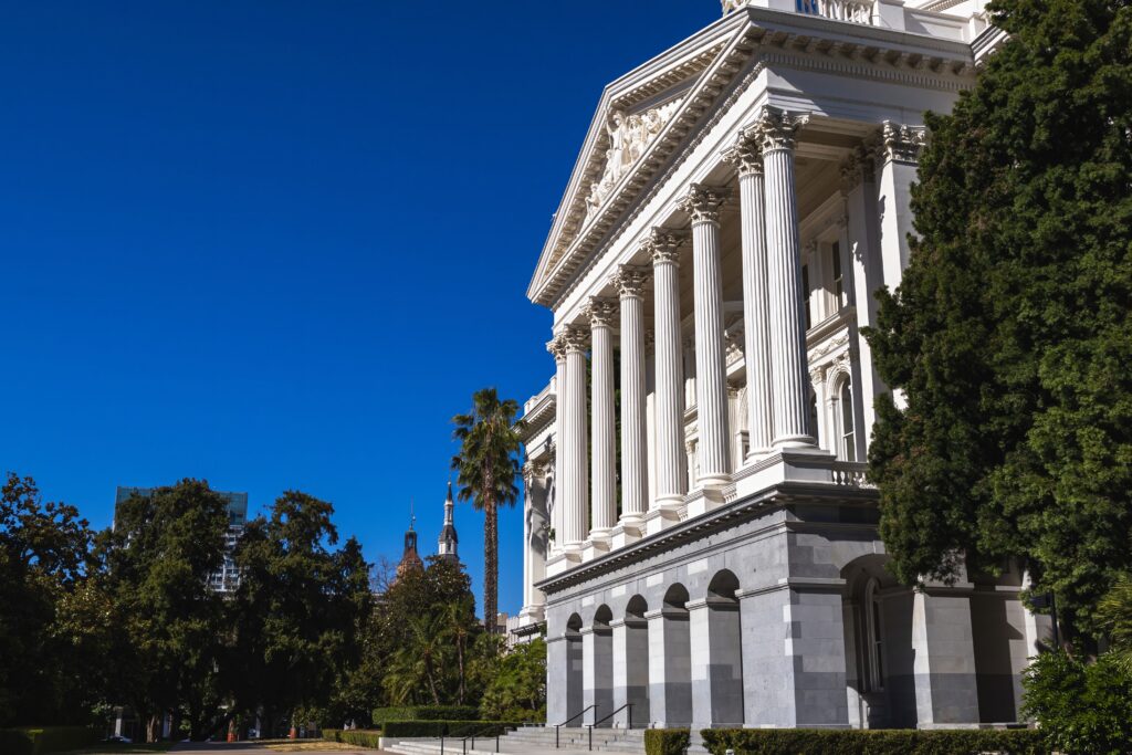 California State Capitol building in Sacramento under a clear blue sky.