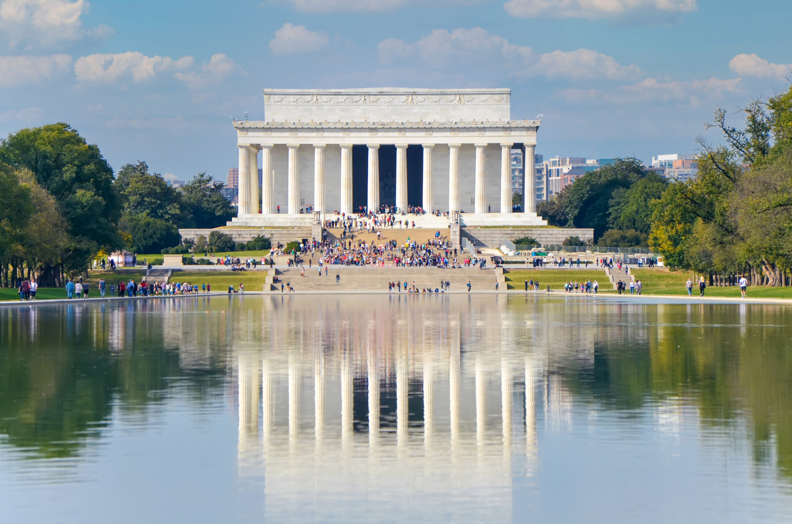 Visitors gather at the Lincoln Memorial reflected in the Reflecting Pool in Washington, D.C.