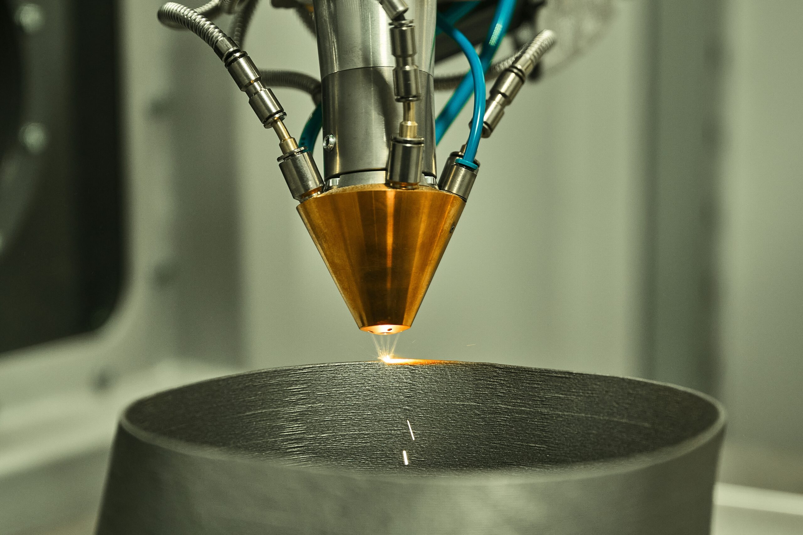 Industrial 3D printer uses a laser to build a component.