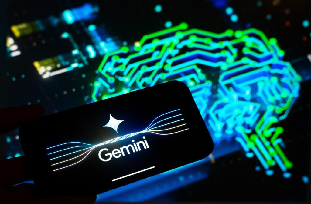 Gemini logo displayed on a smartphone screen with a digital AI brain graphic in the background.