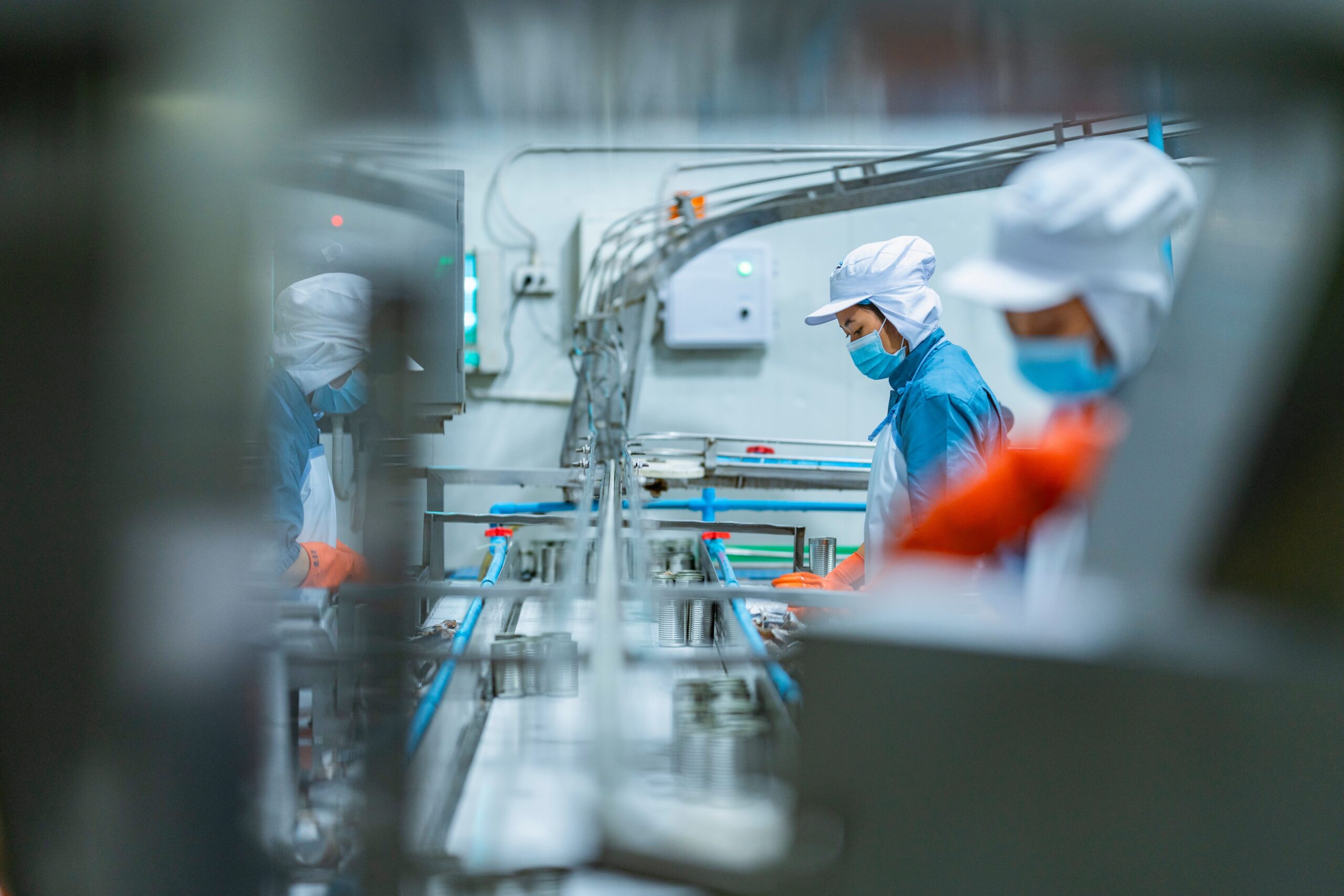 Workers in a manufacturing facility process goods on an assembly line amid growing scrutiny of labor conditions in global supply chains.