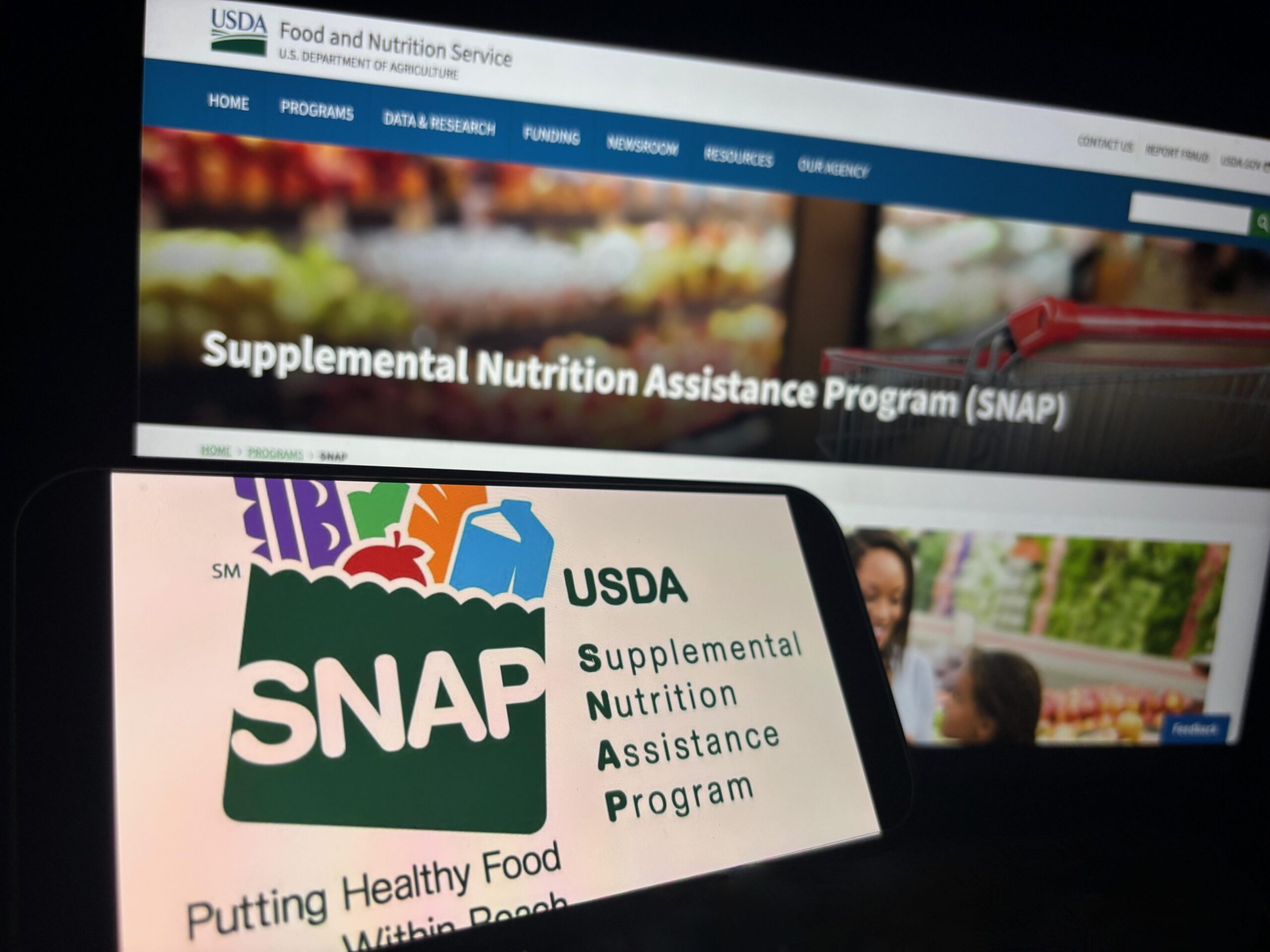 USDA Supplemental Nutrition Assistance Program (SNAP) website displayed on a computer and smartphone.