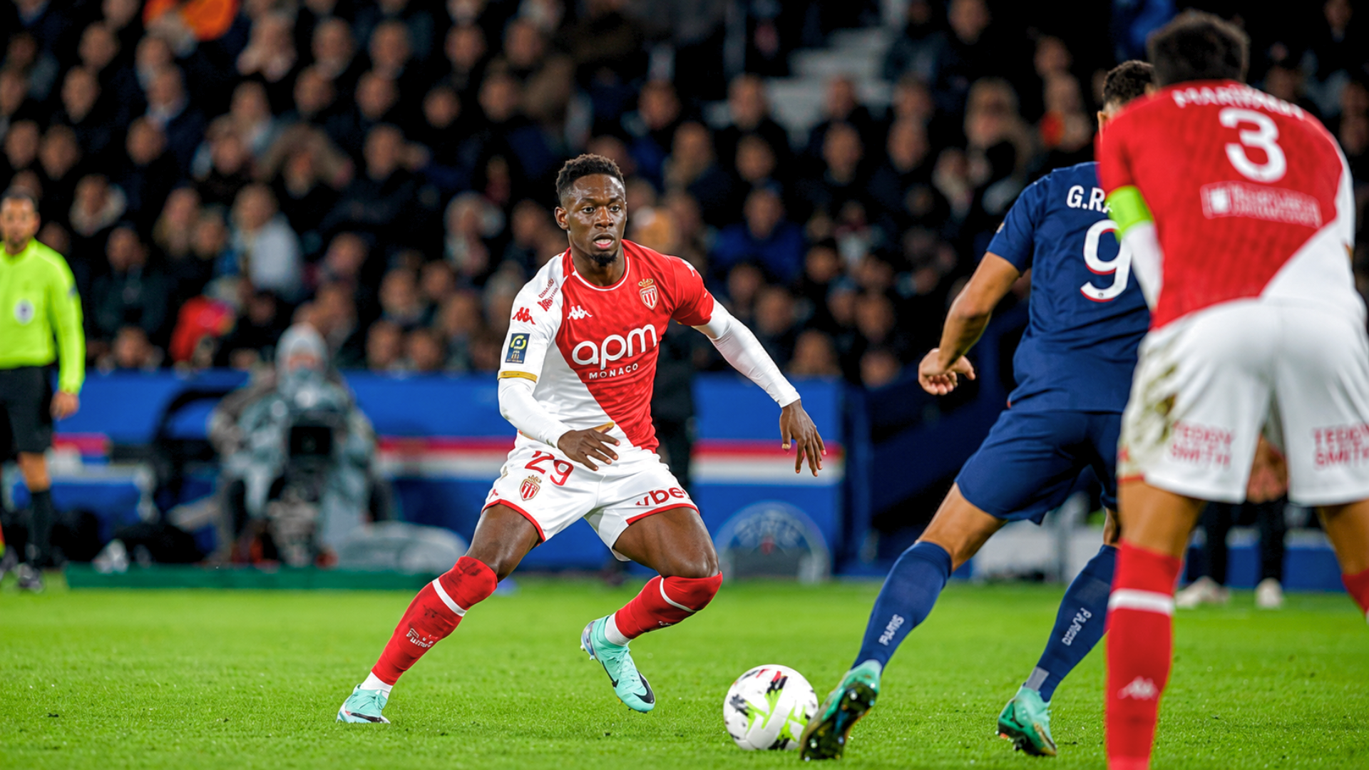 Striker Folarin Balogun dribbles the ball during a soccer match.
