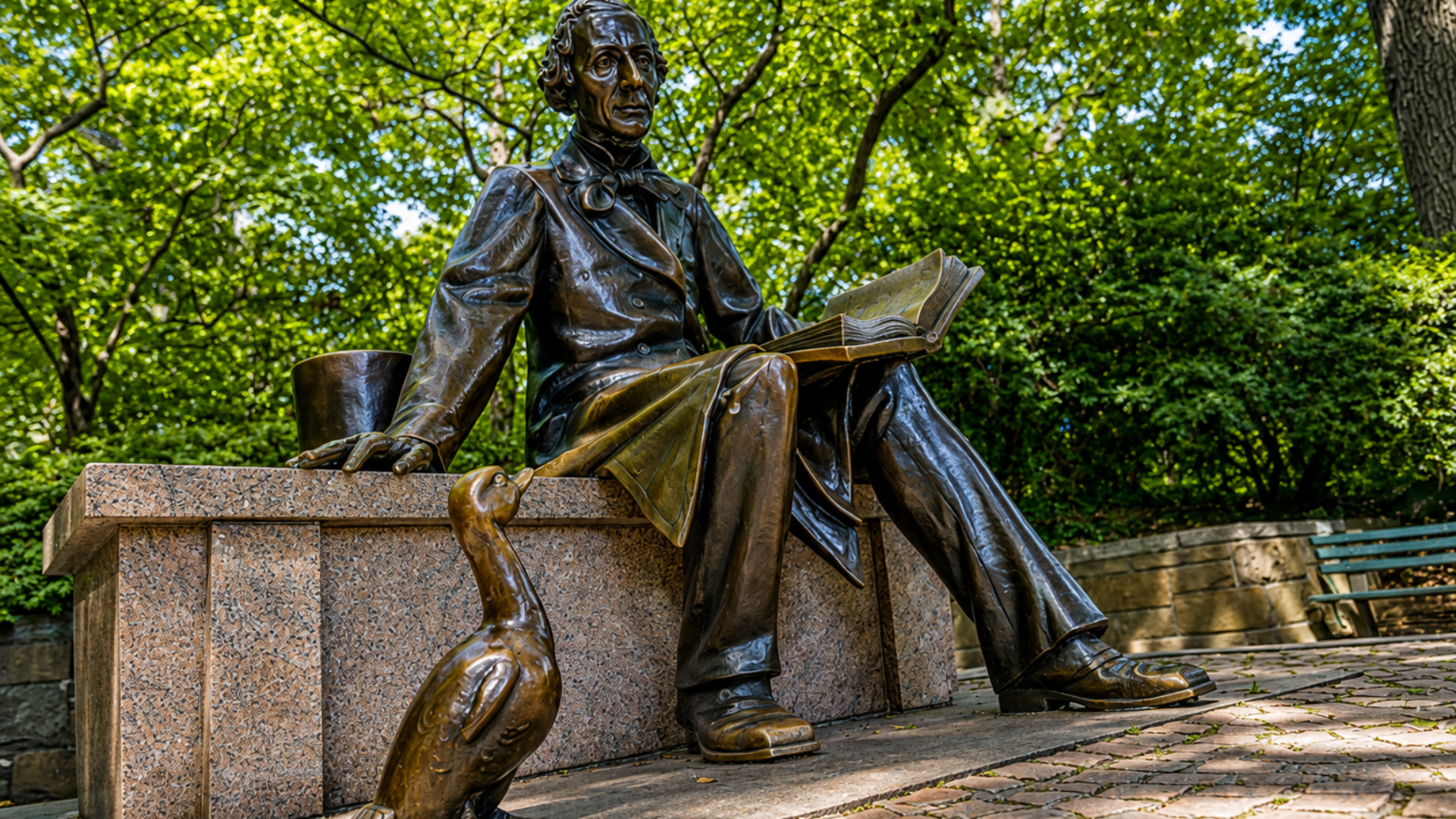 Hans Christian Andersen statue with an open book and the Ugly Duckling in Central Park, New York City.