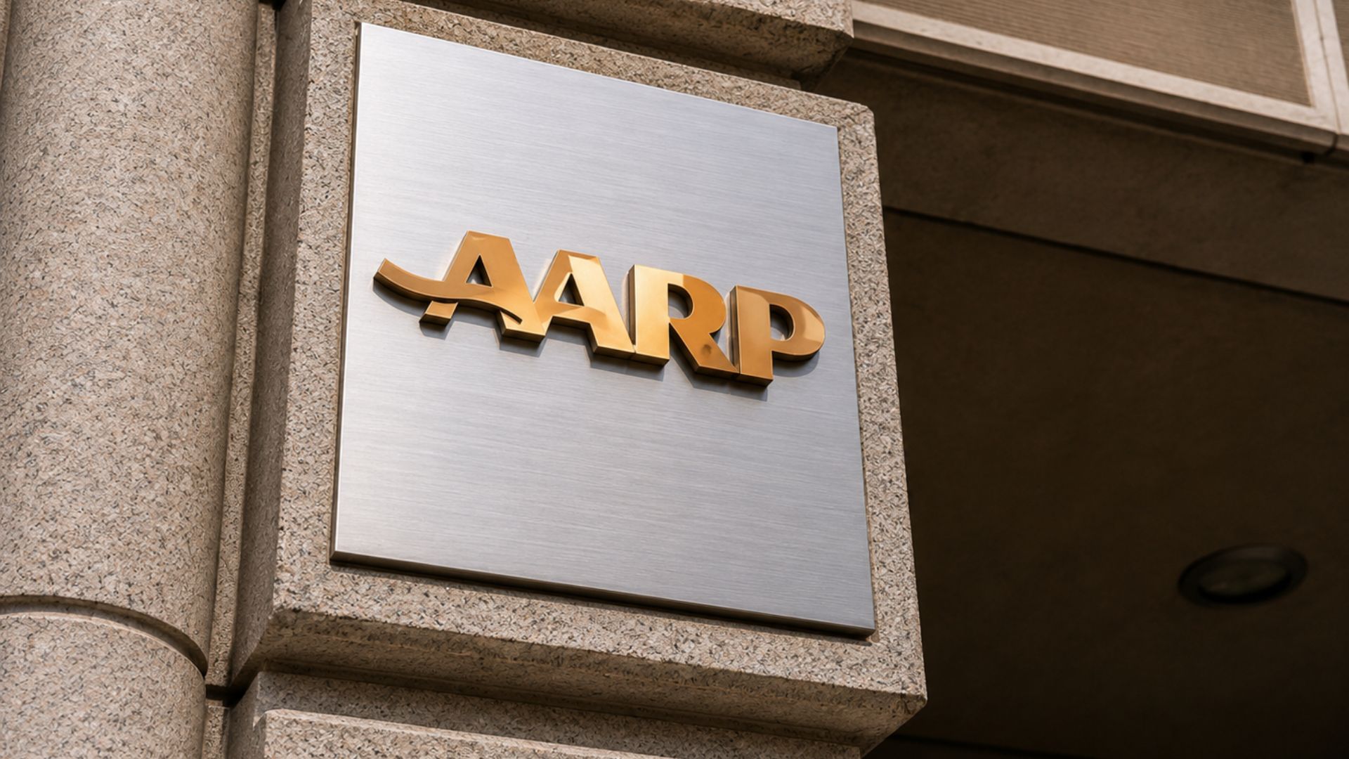 AARP logo displayed on a sign outside an office building.