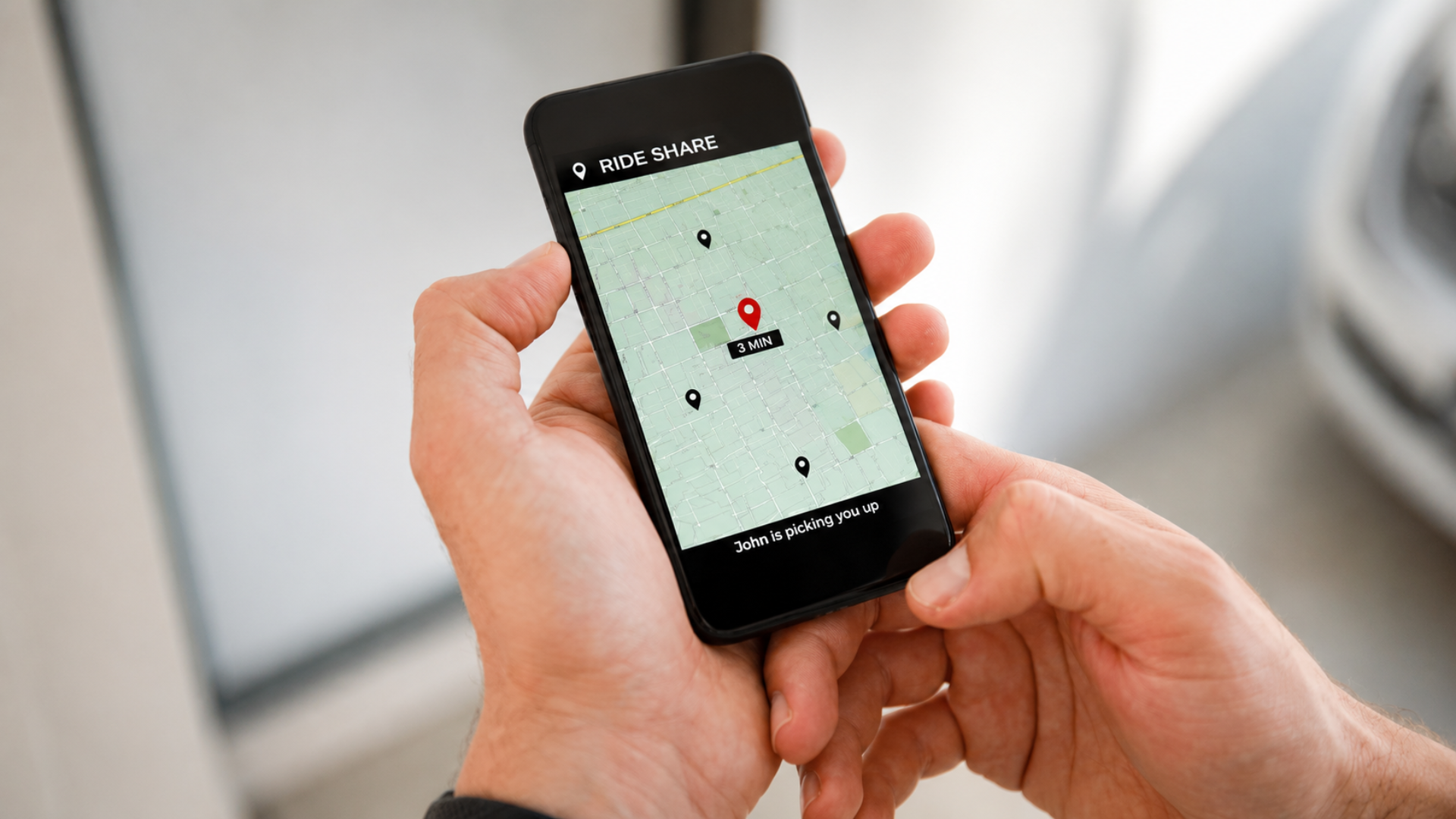 A person holding a smartphone showing a rideshare tracking map on screen.