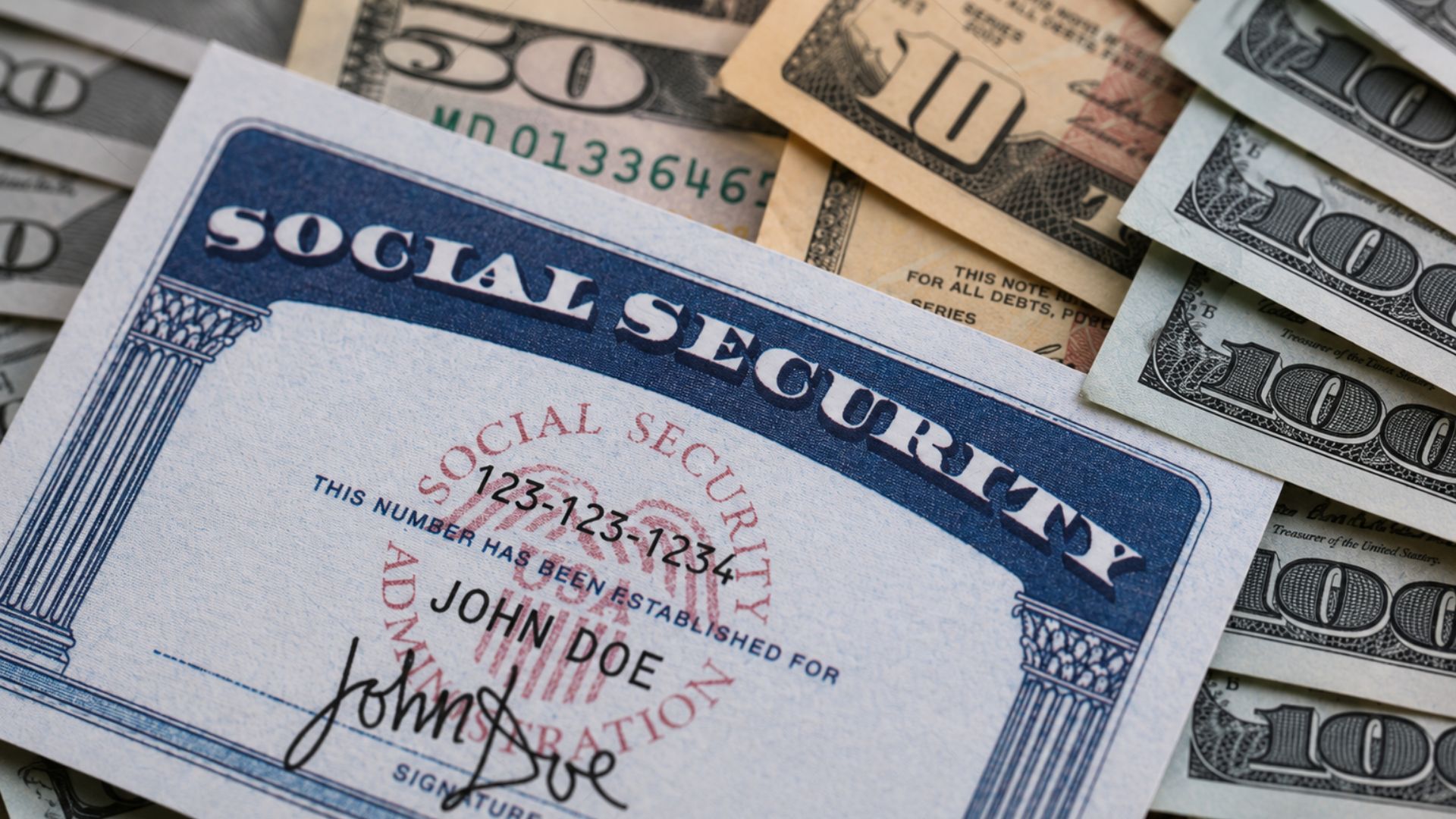 Social Security card placed on U.S. dollar bills to illustrate retirement benefits and personal finances.