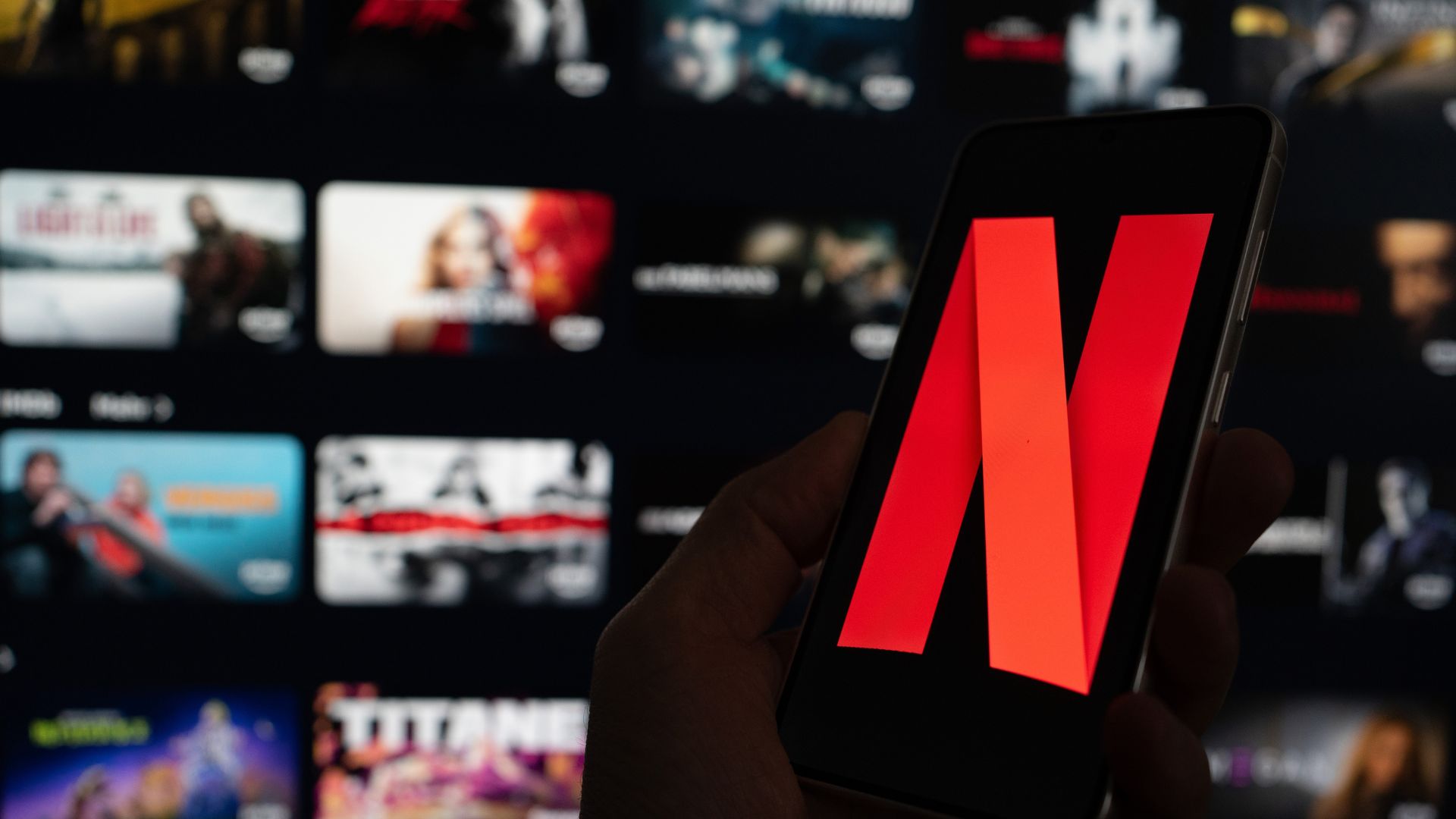 Netflix typography logo to the left and behind it a TV with the tv series in the platform.