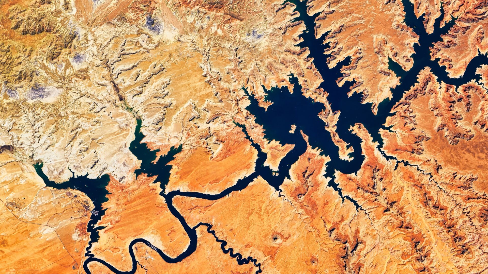 Aerial view of Lake Powell showing the reservoir's shrunken, branching footprint against the surrounding desert.