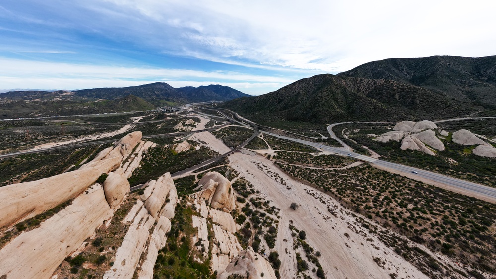 The Cajon Pass Fault Zone in California from A UAV Aerial Drone looking at the dry stream bed with the Trestle Bridges crossing the gap for the trains
