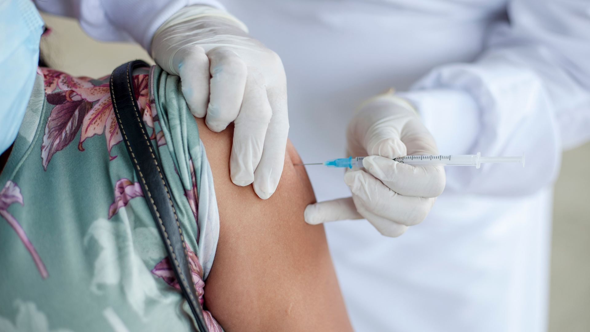 Person receiving vaccine shot arm closeup
