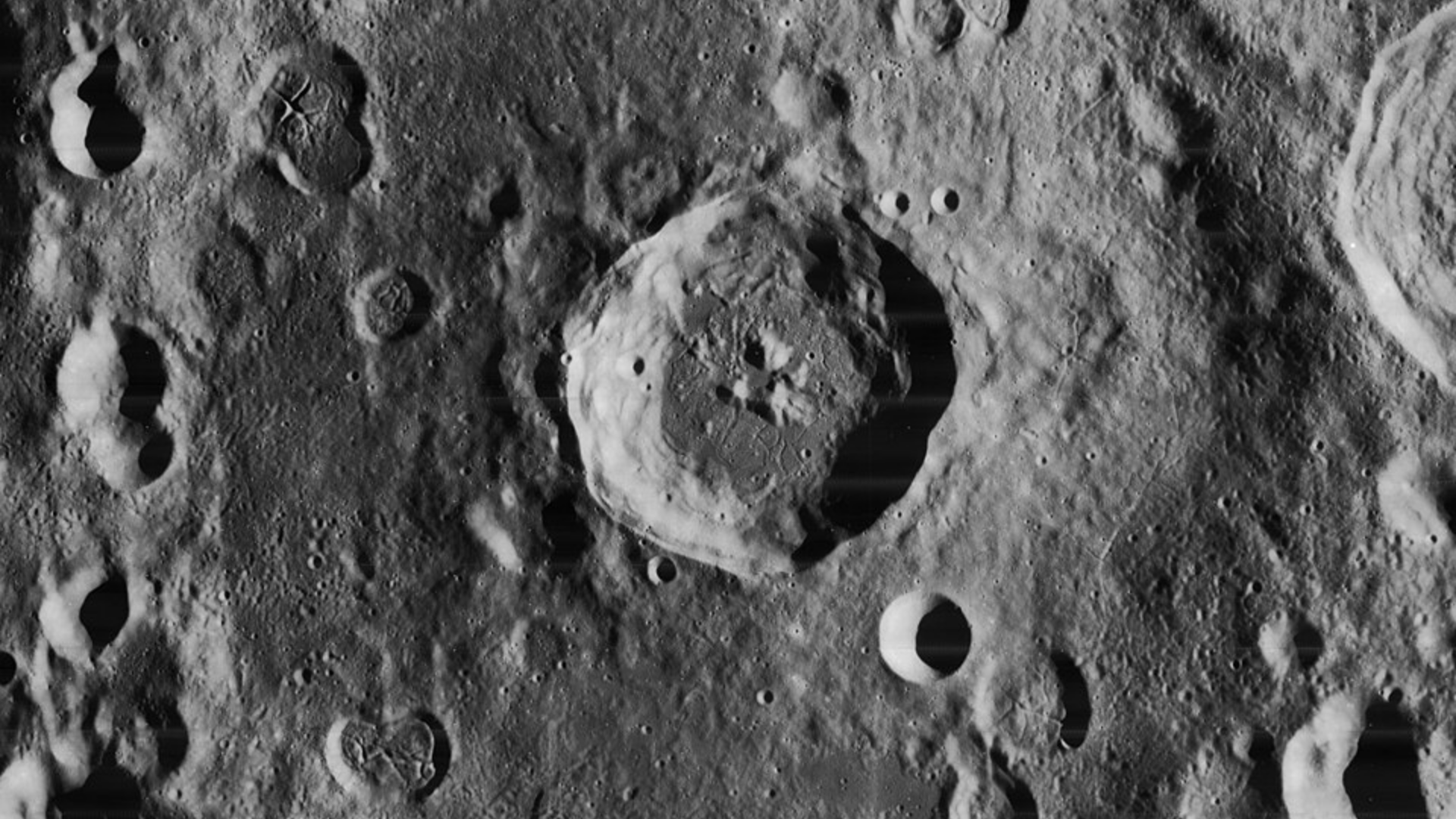 Close-up view of a large impact crater on the Moon's surface captured from orbit.