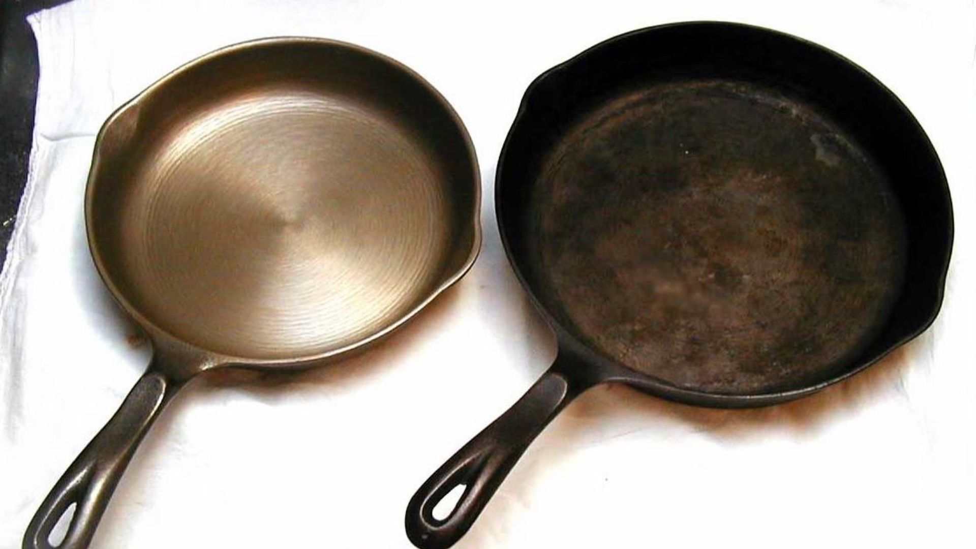 Clean and heavily seasoned cast-iron skillets shown side by side.
