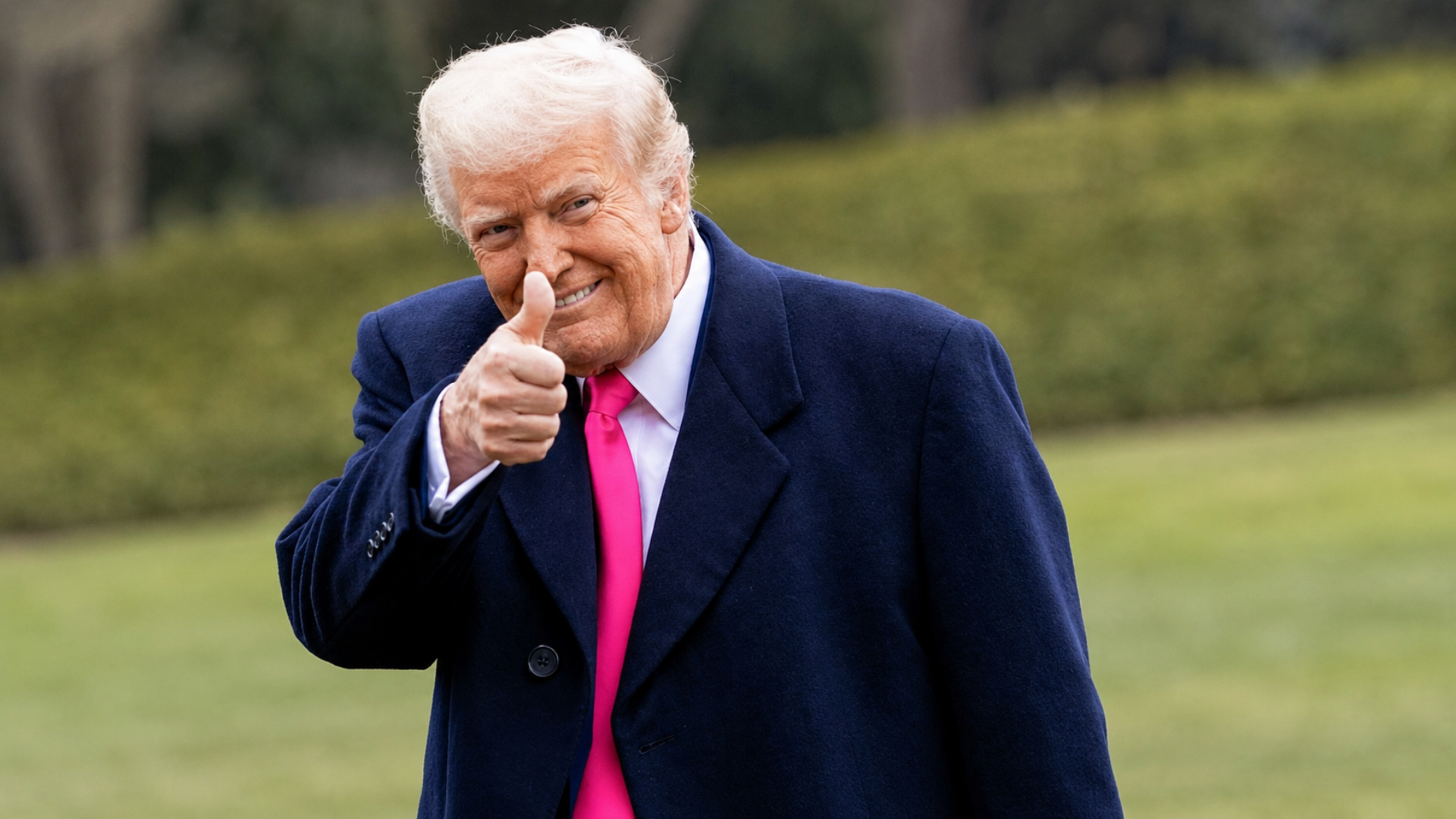 President Donald Trump giving a thumbs-up while outdoors.