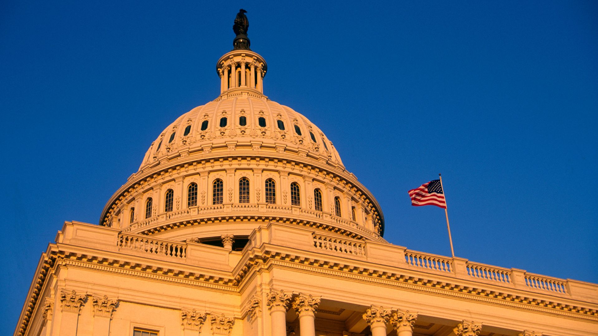 The U.S. Capitol dome at golden hour with the American flag flying, Washington, D.C.