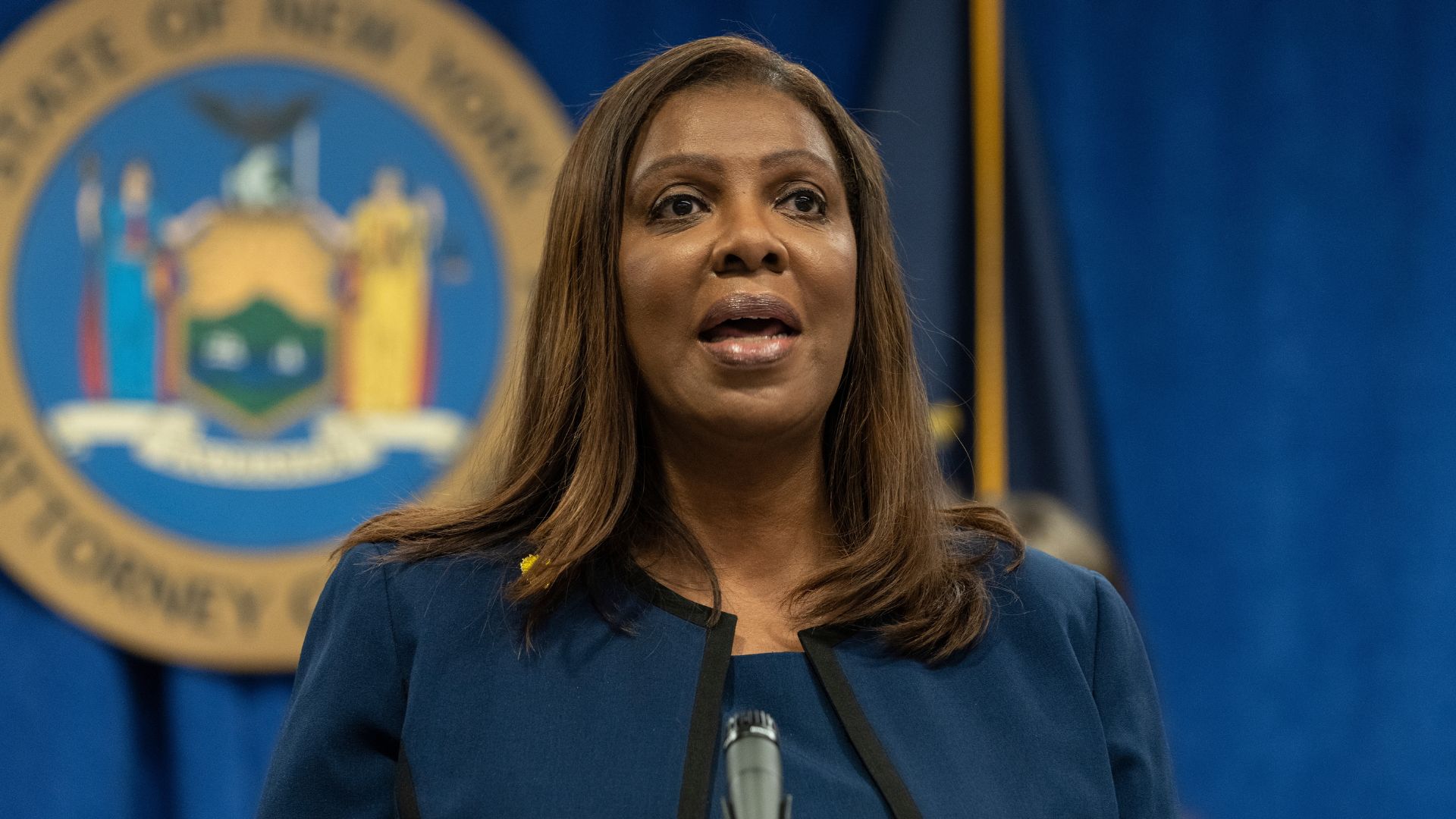 New York Attorney General Letitia James speaking before the New York state seal.
