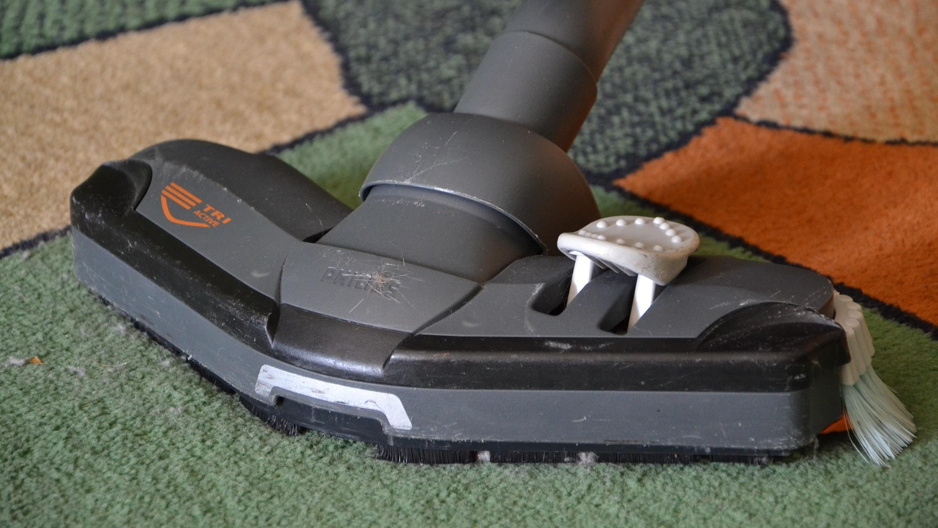 A close-up of a vacuum brush working slowly through thick carpet fibers shows exactly why rushing the job leaves hidden dirt behind. 