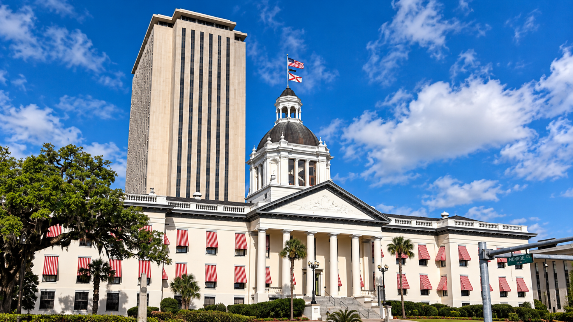 Florida State Capitol building in Tallahassee set against a bright blue sky.