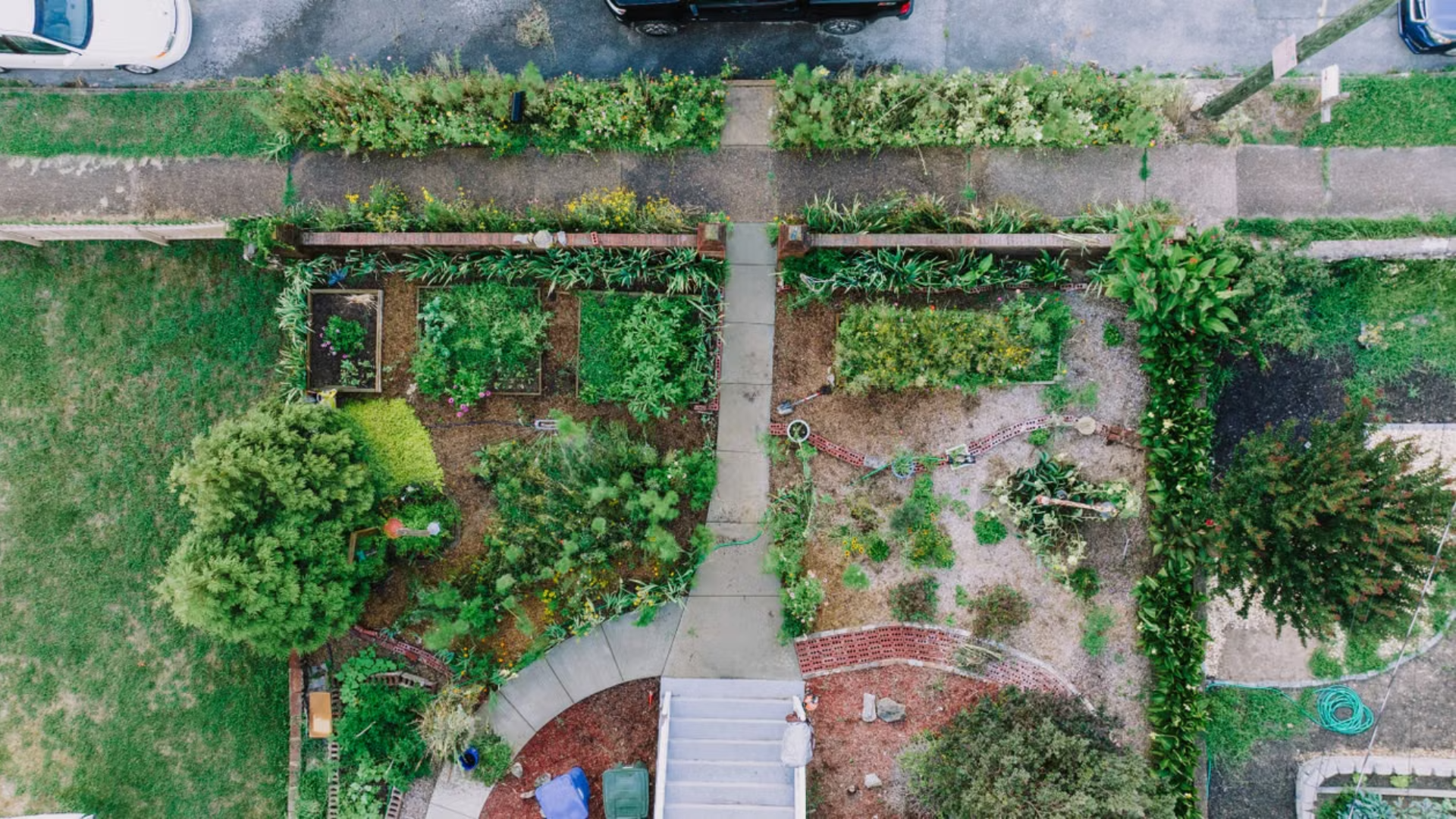 An overhead aerial view shows a residential front yard divided into garden plots with a central walkway.