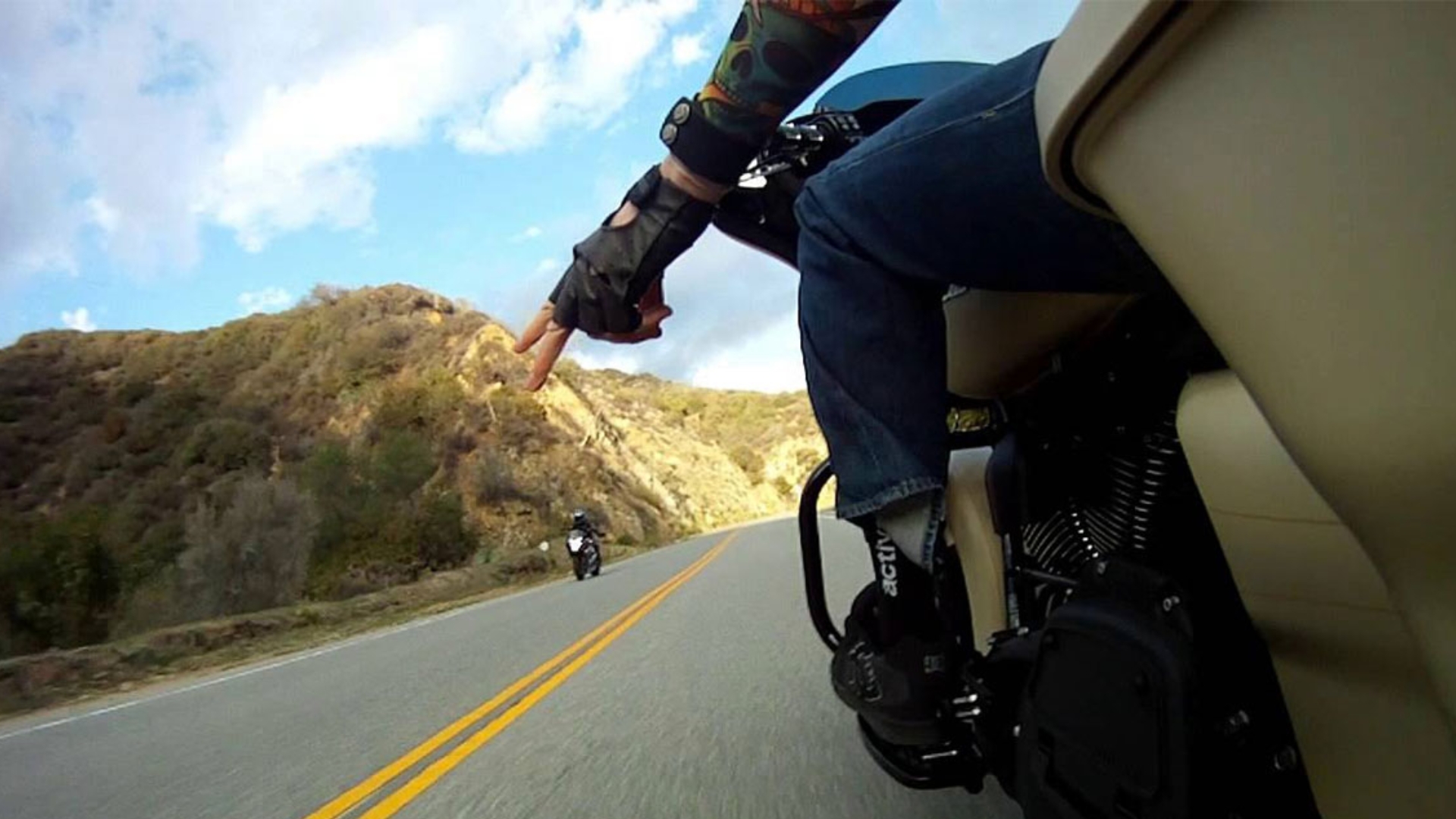 Two fingers down gesture from a motorcyclist.