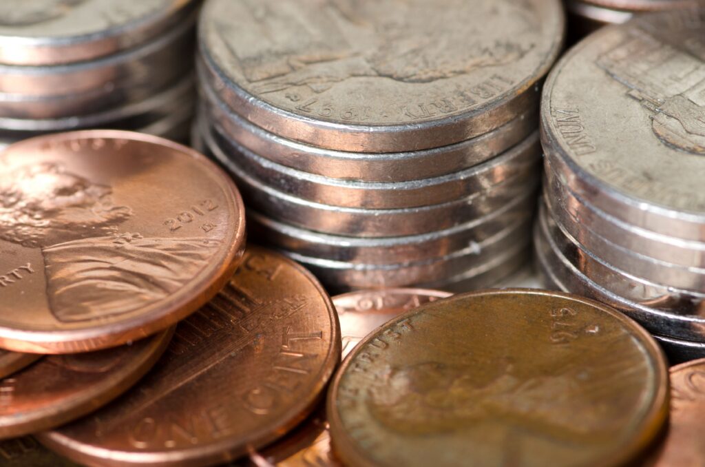 Close-up of U.S. pennies and nickels stacked and scattered together.
