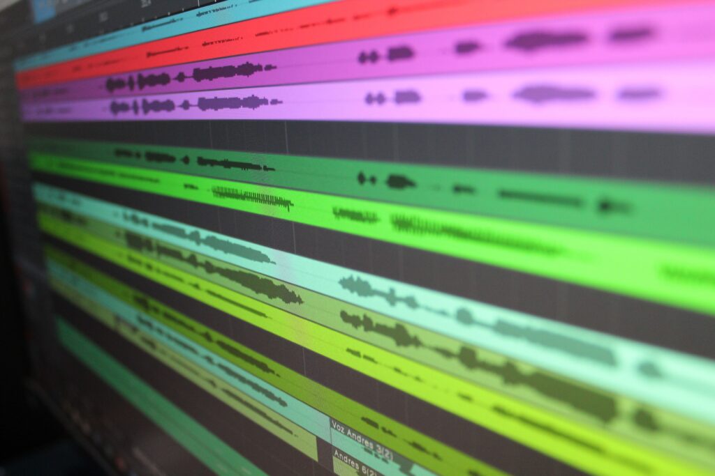Colorful audio waveform tracks displayed on a computer screen, representing the scientific study of low-frequency sound and infrasound vibrations.