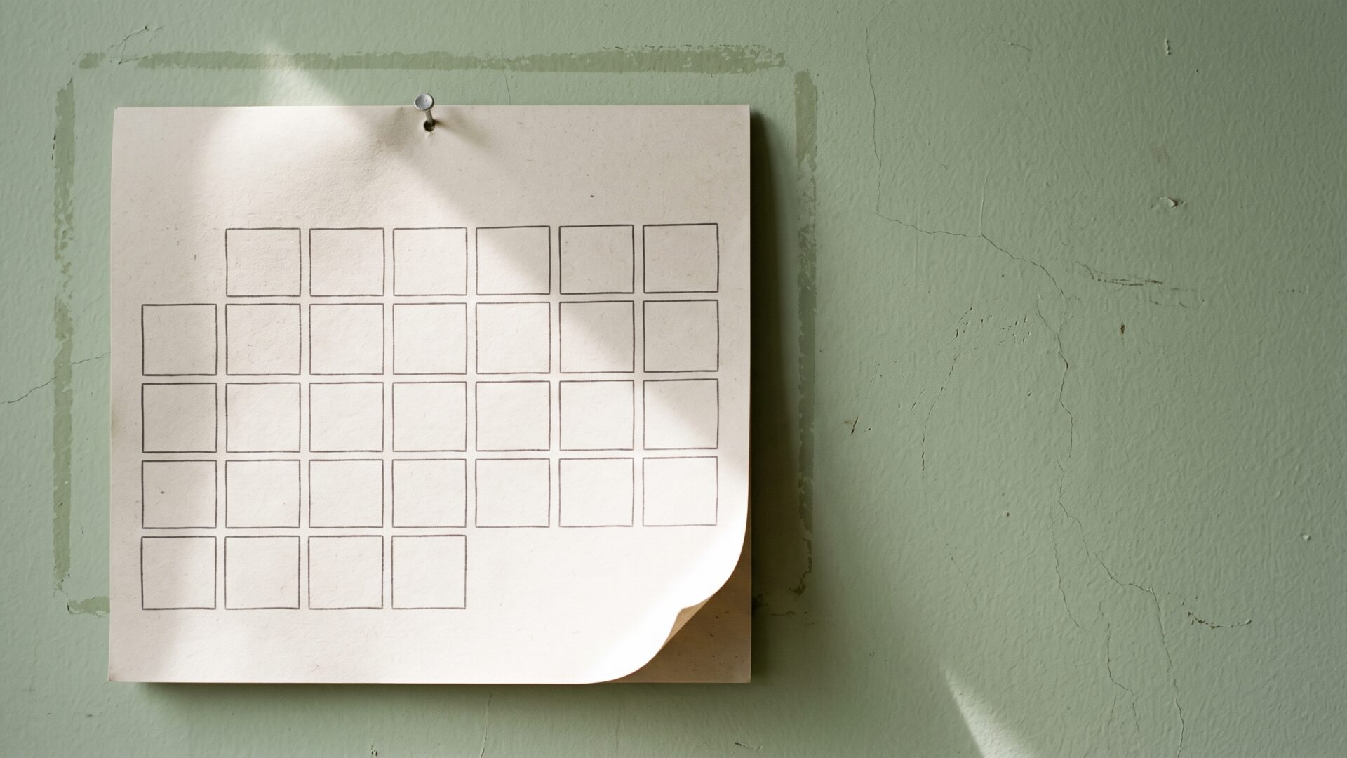 A wall calendar with blank grid squares, the monthly schedule that a 180-day or six-year installment plan imposes.