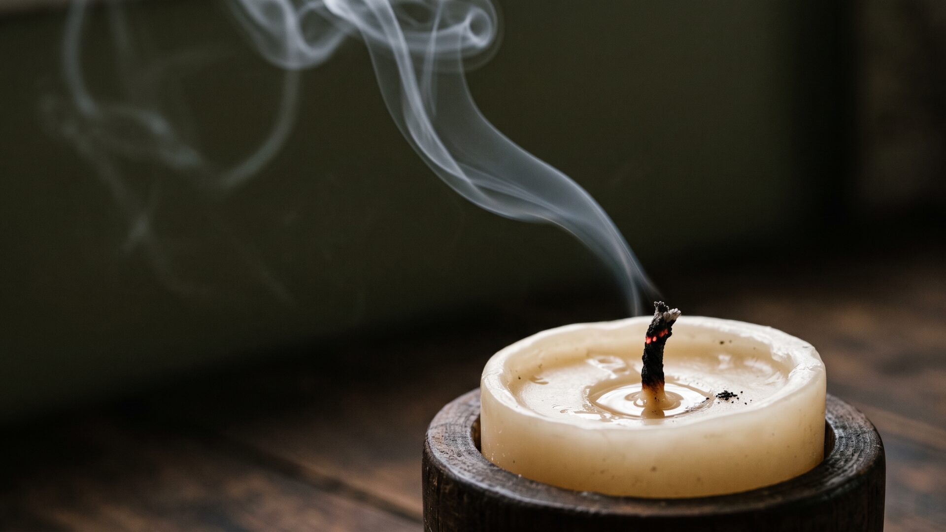 Candle smoke rising in a lit room, the particle source slide 9 describes people adding while trying to clean their air.