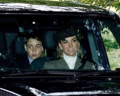 Kate Middleton wearing a seatbelt in the front passenger seat of a black SUV, with Prince George seated behind her.